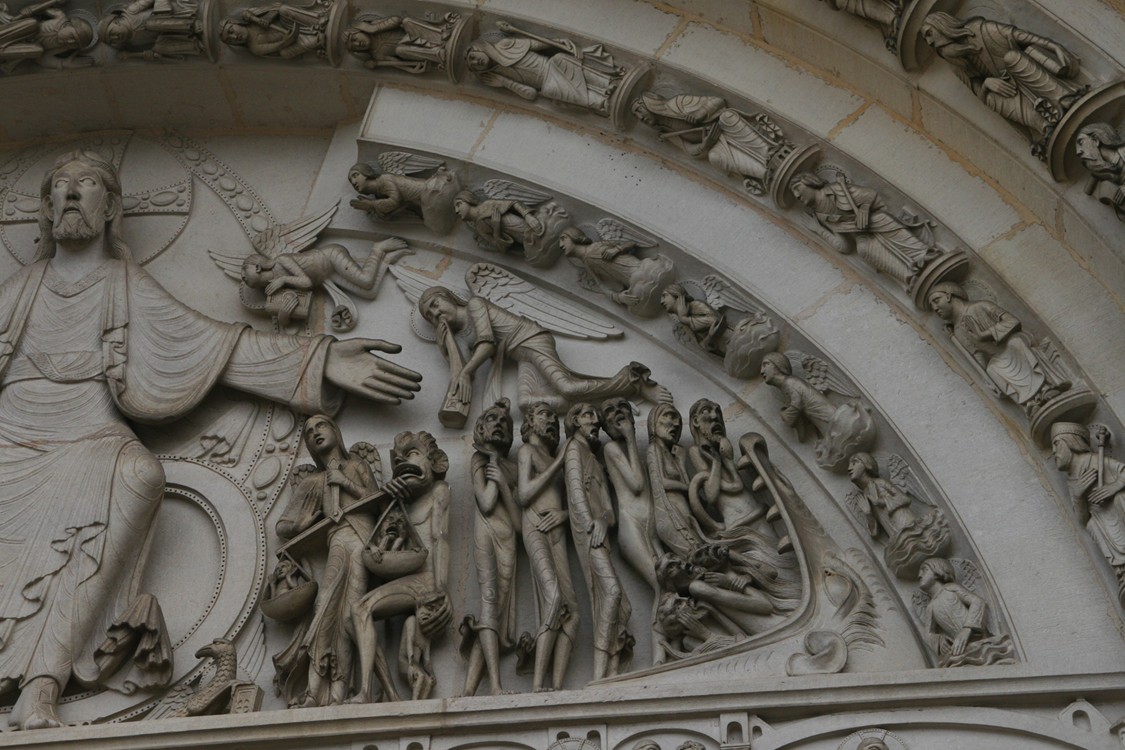 Figure 10-4: The tym- panum over the entrance doors of the Basilica of Ste-Madeleine, a pilgrimage church in Vezelay, depicts a medieval vision of the Last Judgment.